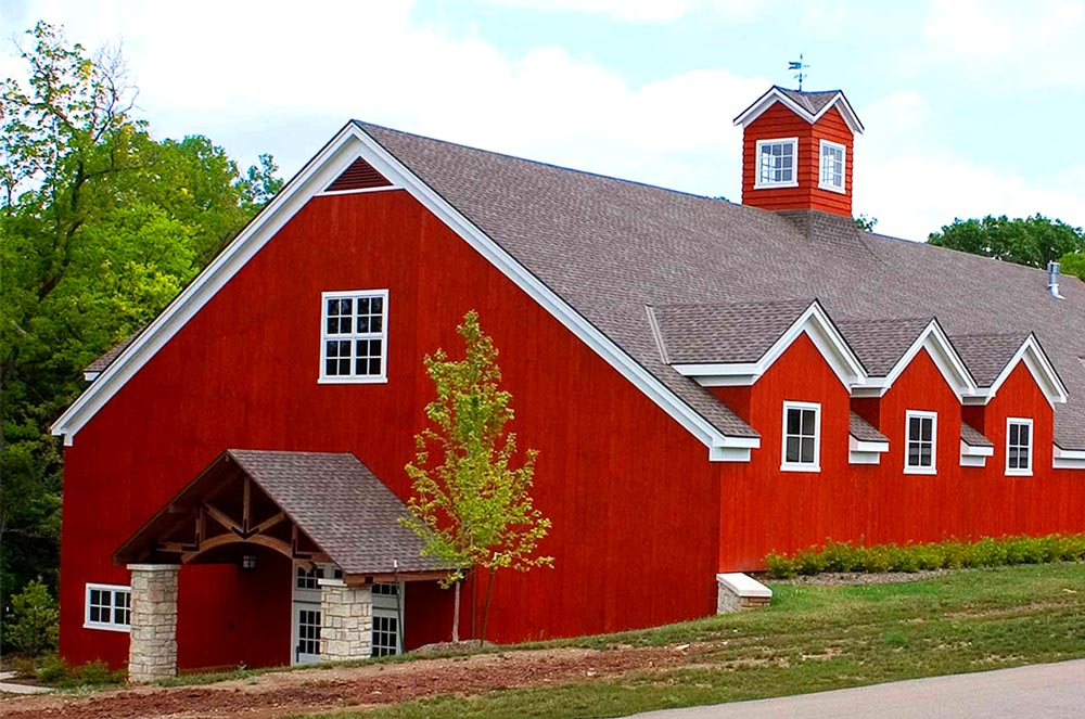 The large red barnwood building the Lodge at Ironwoods owned by Leawood Parks and Recreation near Kansas City where community theatre plays and musicals are held